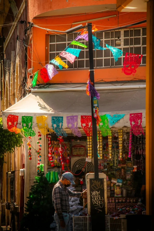 Papel picado decorations hanging above a street in Guadalajara, Mexico